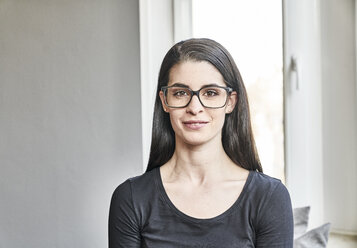 Portrait of smiling young woman with glasses - FMKF04002