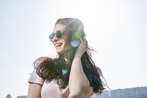 Happy young woman outdoors in sunshine stock photo