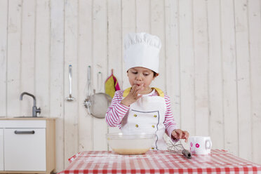 Little girl preparing waffles, wearing chef's hat - DRF01723