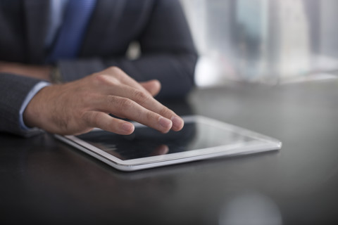 Businessman using tablet on table stock photo