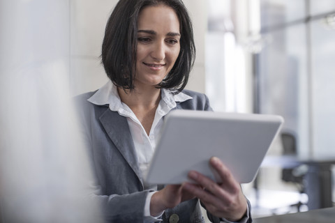 Businesswoman holding digital tablet in office stock photo