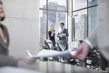 Businessman talking to woman in city office - ZEF13599