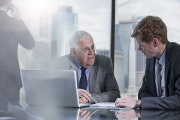 Businessmen with laptop discussing in office - ZEF13665