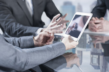 Businesspeople using tablet in meeting - ZEF13666