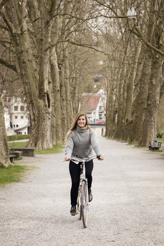 Young woman riding bicycle stock photo