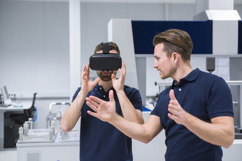 Two men in testing instrument room with VR glasses stock photo