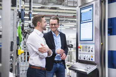 Two smiling men talking in factory shop - DIGF02179