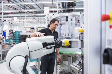 Man with assembly robot in factory - DIGF02228