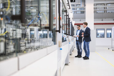 Two men with tablet in factory shop floor - DIGF02268