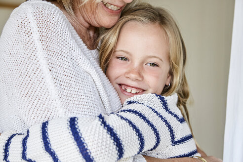 Portrait of happy little girl hugging her grandmother - SRYF00289