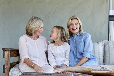 Little girl sitting together with grandmother and mother on terrace - SRYF00319