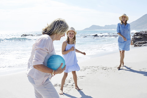 Family playing ball at the sea stock photo