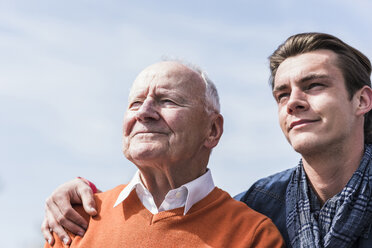 Smiling senior man and adult grandson outdoors - UUF10456