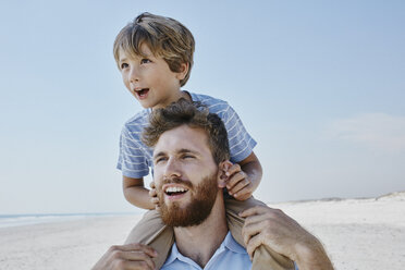 Father carrying son piggyback on the beach - RORF00765