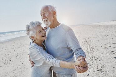 Happy senior couple dancing on the beach - RORF00779