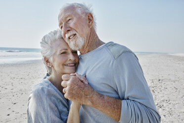Happy senior couple dancing on the beach - RORF00780