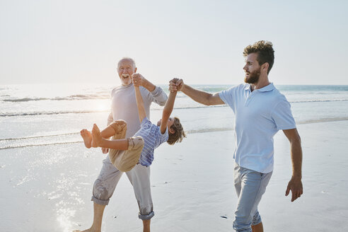 Happy grandfather, father and son on the beach - RORF00785