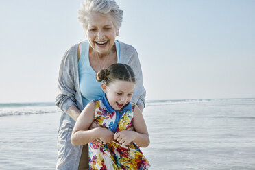 Happy grandmother with granddaughter on the beach - RORF00786