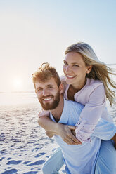 Portrait of happy couple on the beach - RORF00803