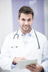 Portrait of smiling doctor using tablet - WESTF22991