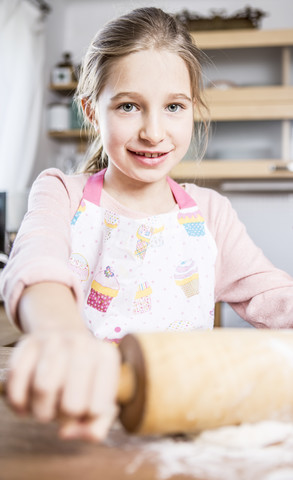 Portrait of smiling girl baking in kitchen stock photo