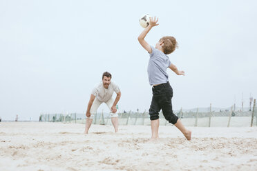 Father and little son playing with ball on the beach - MVCF00154