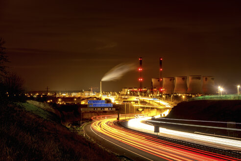 UK, England, West Yorkshire, view to Ferrybridge power station by night with motorway in the foreground - SMAF00738