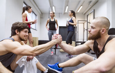 Athletes having a break from exercising in gym - HAPF01639