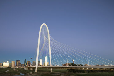USA, Texas, Dallas, Margaret Hunt Hill Bridge and skyline at dusk - FOF09228
