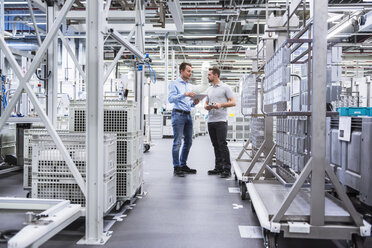 Two men with tablet talking in factory shop floor - DIGF02342