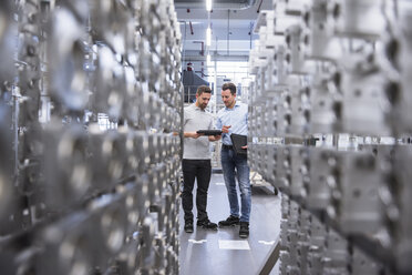 Two men with tablet talking in factory shop floor - DIGF02351