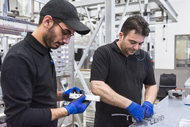 Two men working in factory shop floor - DIGF02358