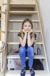 Portrait of girl sitting on ladder of her loft bed - TCF05390