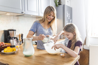 Mutter und Tochter bereiten in der Küche Pfannkuchen zu - TCF05402