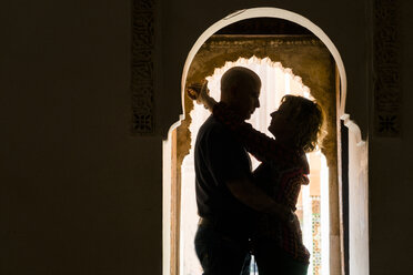 Morocco, Marrakesh, couple hugging in doorframe - KKAF00769