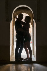 Morocco, Marrakesh, couple hugging in doorframe - KKAF00770