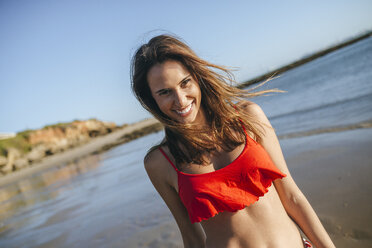 Portrait of happy young woman on the beach - KIJF01461