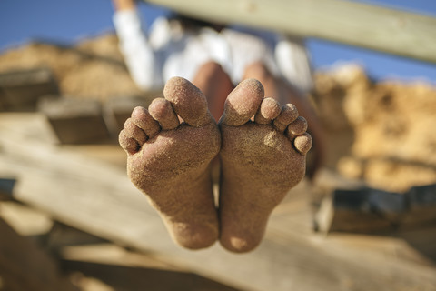 Sandy feet of woman on the beach stock photo
