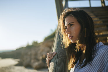 Young woman relaxing on the beach at sunset - KIJF01465