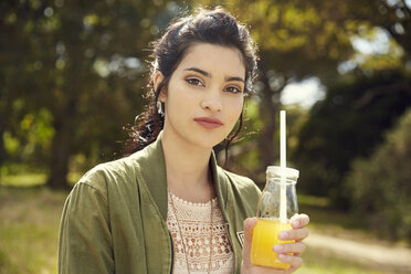 Portrait of young woman with glass of juice - SRYF00486