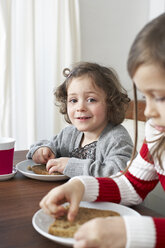 Portrait of smiling little girl at breakfast table - FSF00831