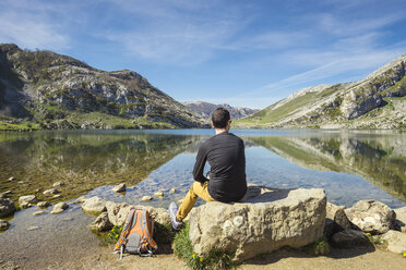 Spain, Asturias, Picos de Europa National Park, man sitting at Lakes of Covadonga - EPF00438