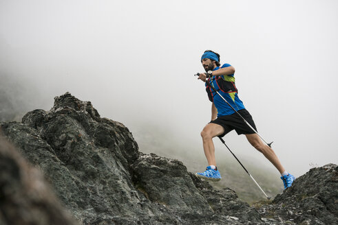 Italy, Alagna, trail runner on the move near Monte Rosa mountain massif - ZOCF00272