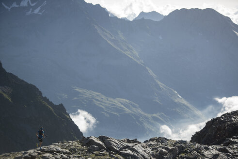 Italy, Alagna, trail runner on the move near Monte Rosa mountain massif - ZOCF00276