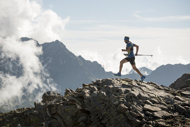 Italy, Alagna, trail runner on the move near Monte Rosa mountain massif - ZOCF00278