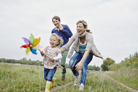 Family on a trip with daughter holding pinwheel stock photo