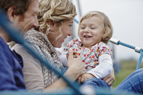 Happy family on playground in climbing net - RORF00857