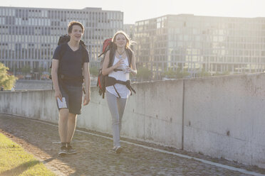 Germany, Berlin, Young couple traveling Berlin with backpacks - MVCF00175