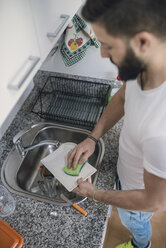 Overhead view of a young man washing dishes - RAEF01874