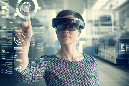 Woman wearing mixed reality smartglasses touching transparent screen - RBF05665